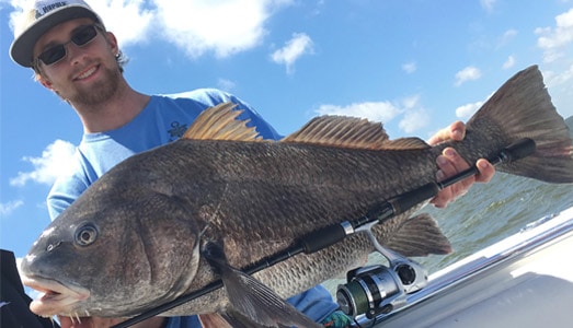 Angler holding his catch from a Galveston bay & jetty fishing trip