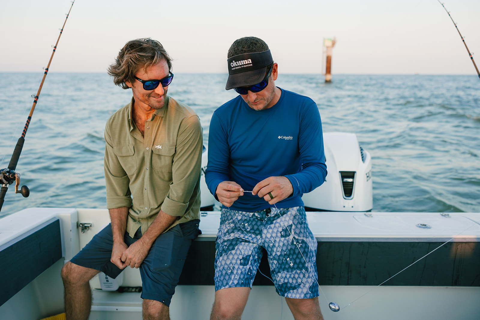 Two friends chat on the stern of a Galveston Fishing Boat.