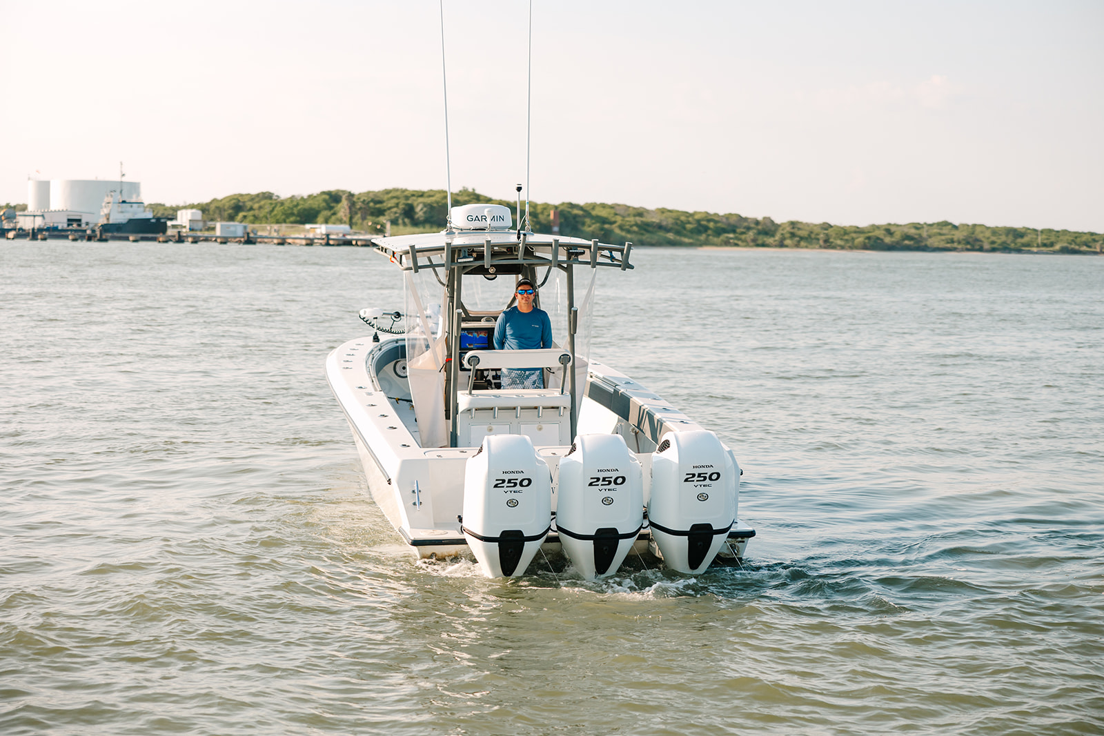 A rear view of 3 large boat motors on a Galveston Fishing Boat.