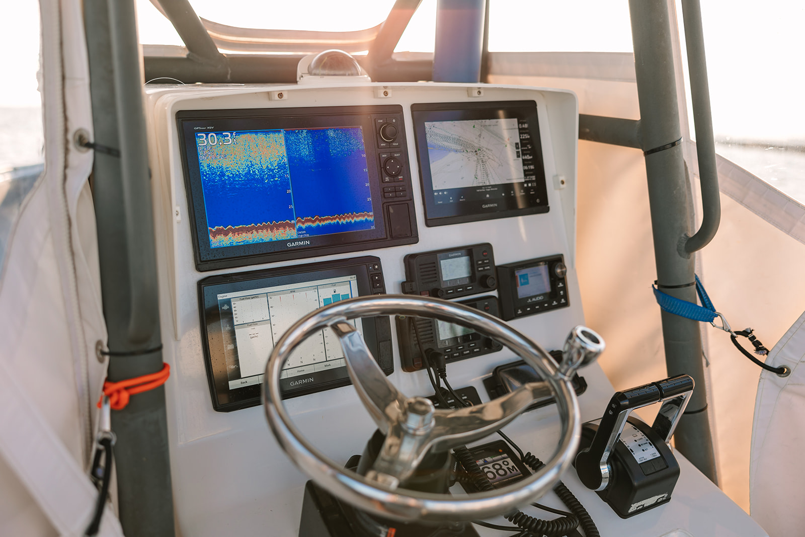 The helm, steering wheel and navigation instruments aboard a Galveston Fishing Boat.