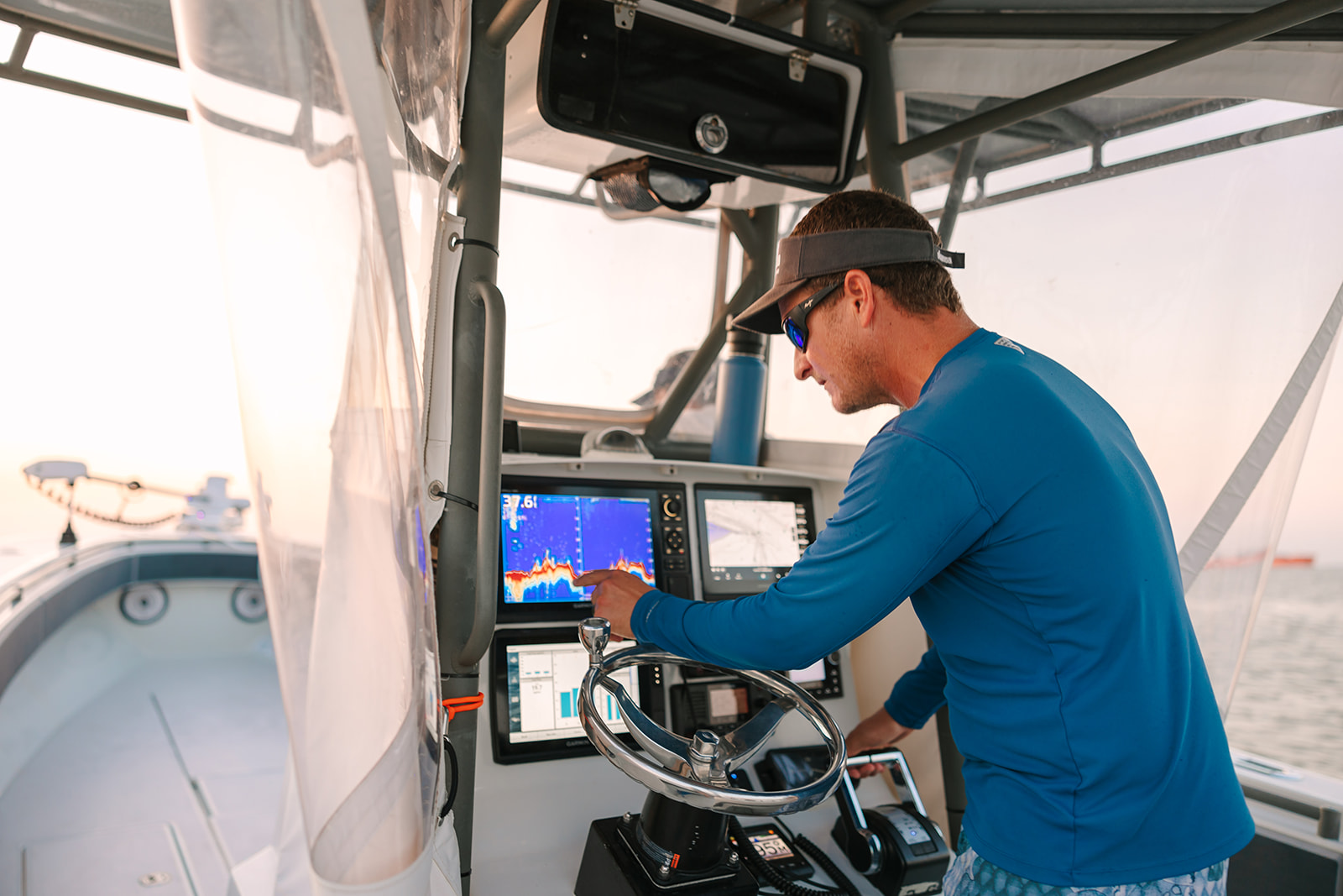 Captain Shane checking the instruments of his Galveston Fishing Boat.