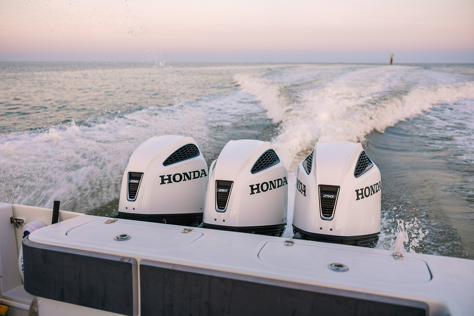 A view off the rear bow while the boat cruises fast across Gaveston Bay.