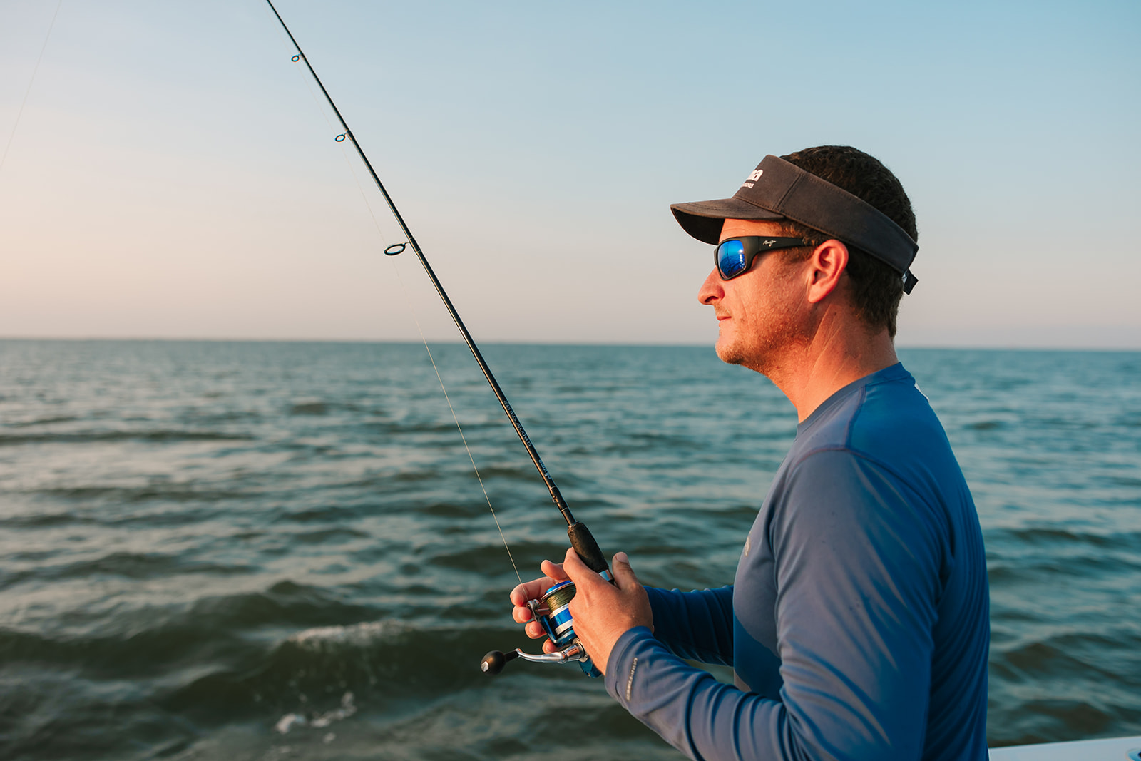 Captain Shane holds his rod on a Galveston Fishing Charter.