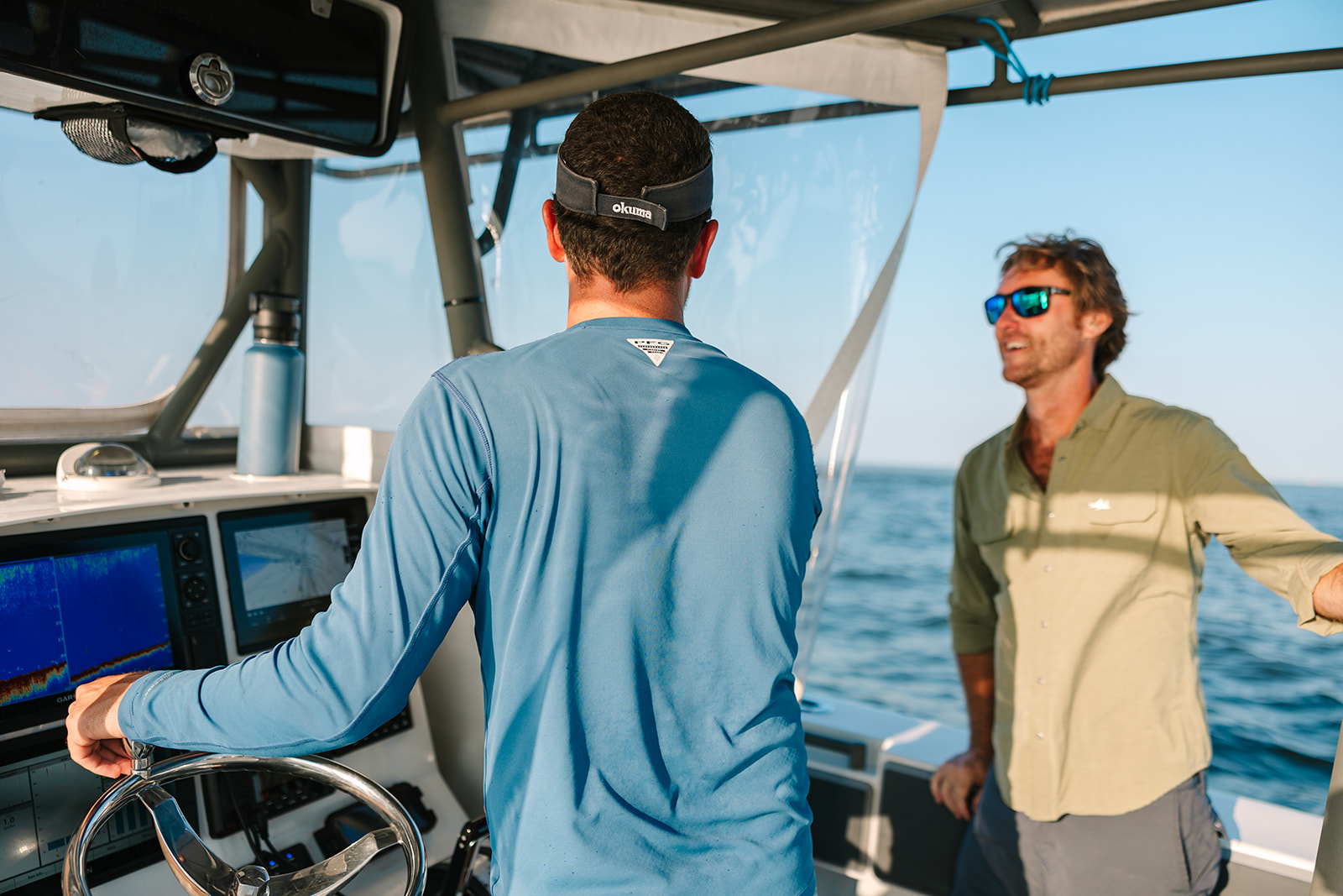 Two friends chat at the helm of a Galveston Fishing Boat.