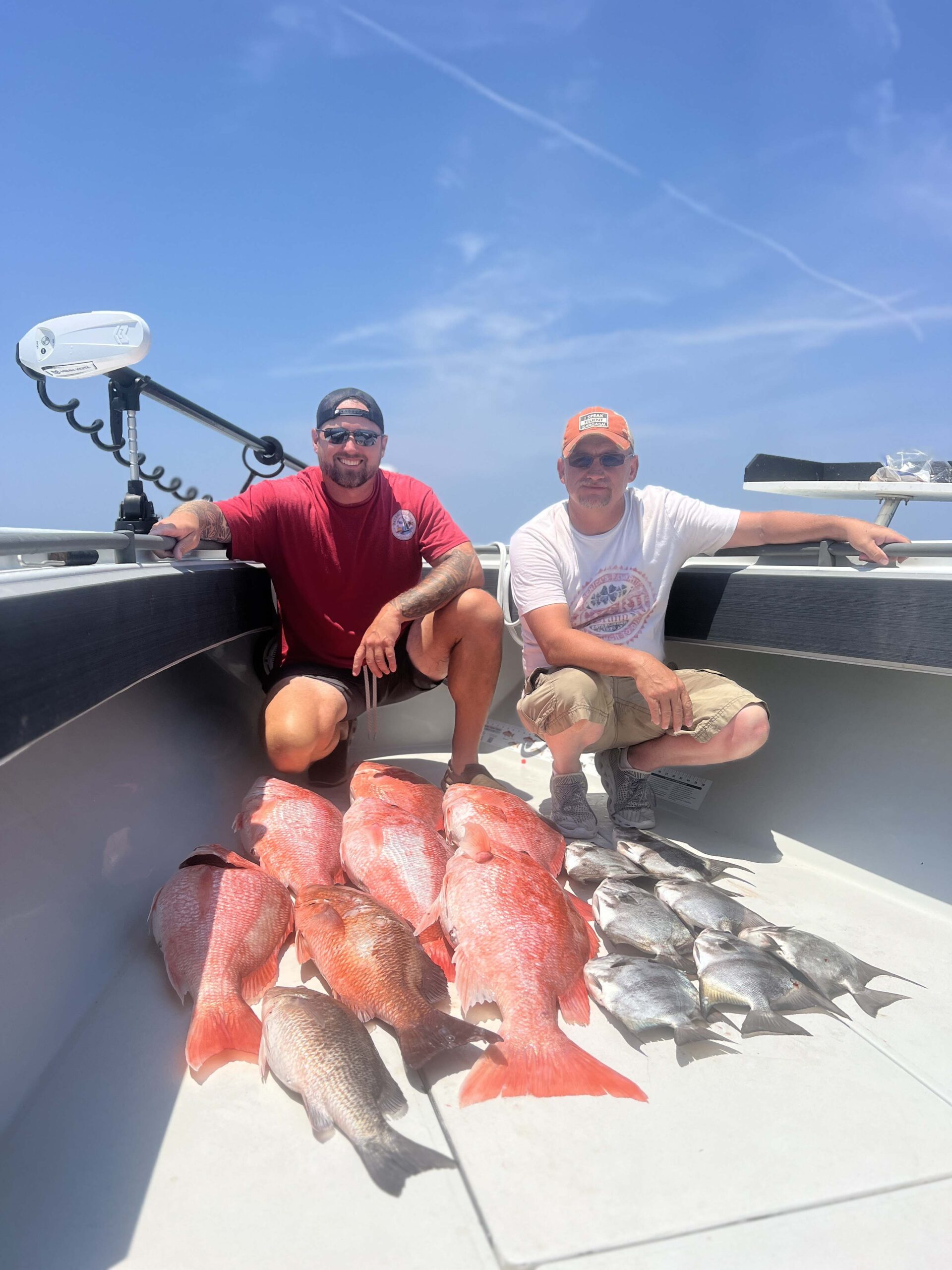 Father and son pose with their catch on the bow of a Galveston Deep Sea Fishing boat.