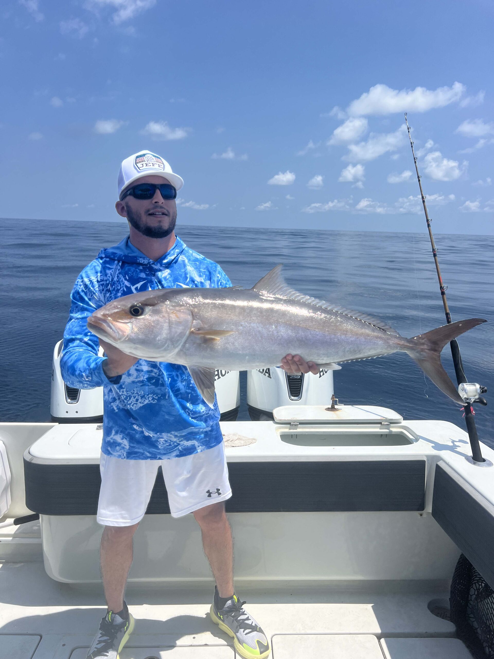 Fisherman poses with his catch on a Galveston Fishing Charter.